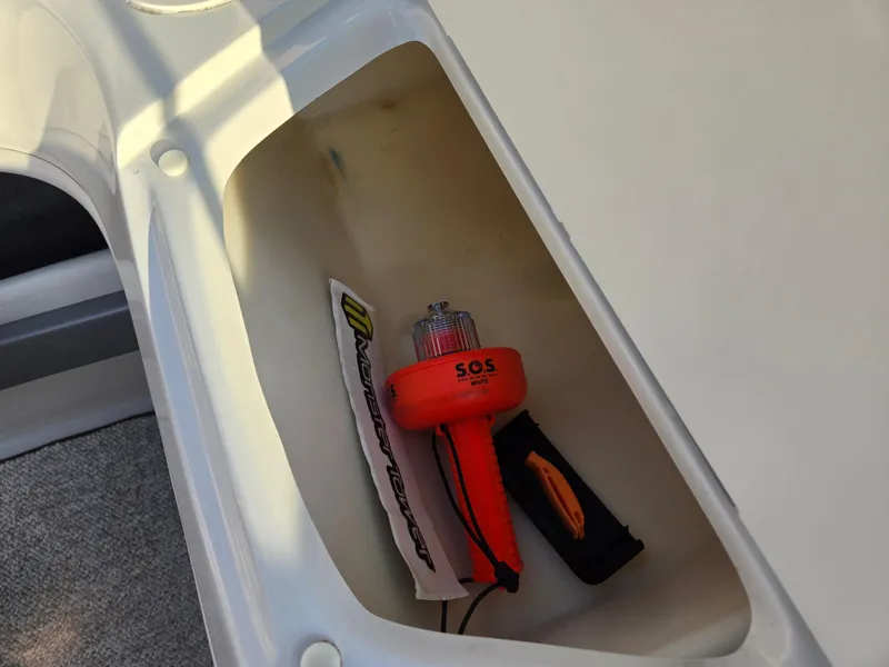 Slide: The Image of Storage compartment in a 2008 Sea Ray 205 Sport boat with safety equipment. - 35