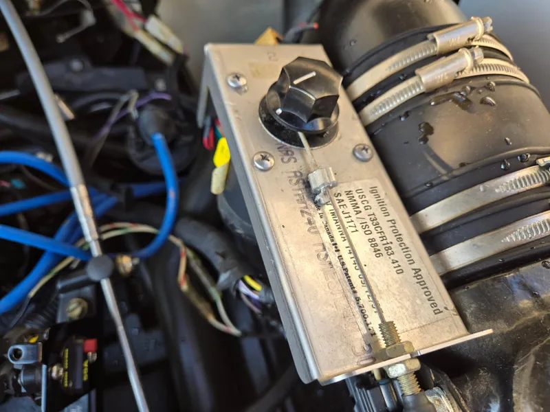 Slide: The Image of Close-up of a 2008 Sea Ray 205 Sport engine component with wiring and ignition protection label. - 38