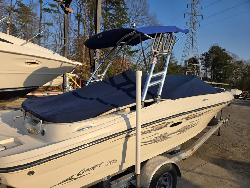 Slide: The Image of 2008 Sea Ray 205 Sport boat on trailer with blue cover and canopy. - 5
