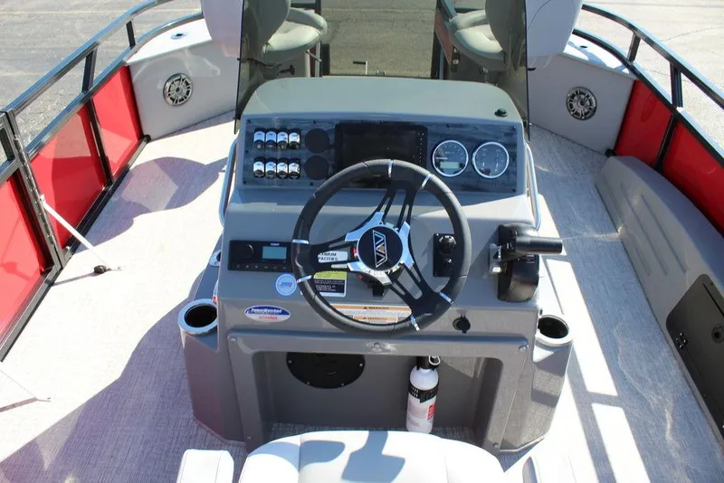 Slide: The Image of 2025 Avalon Venture 85 Center Console Fish boat interior with steering wheel and control panel. - 19