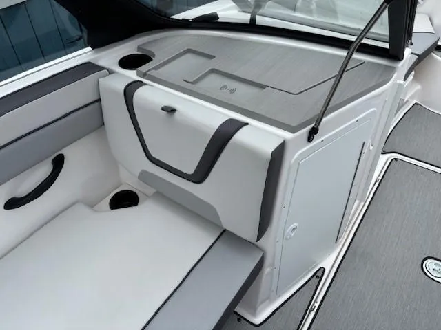 Slide: The Image of 2023 Yamaha Boats AR220 interior with sleek seating and storage compartments. - 12