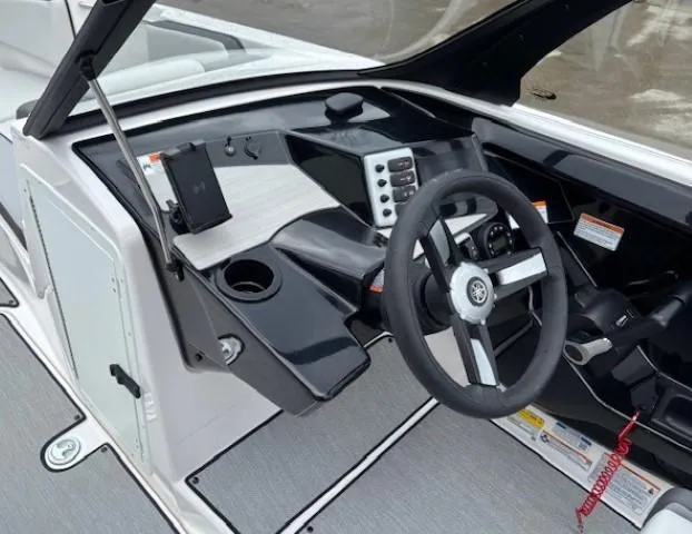 Slide: The Image of 2023 Yamaha Boats AR220 dashboard with steering wheel and control panel. - 13