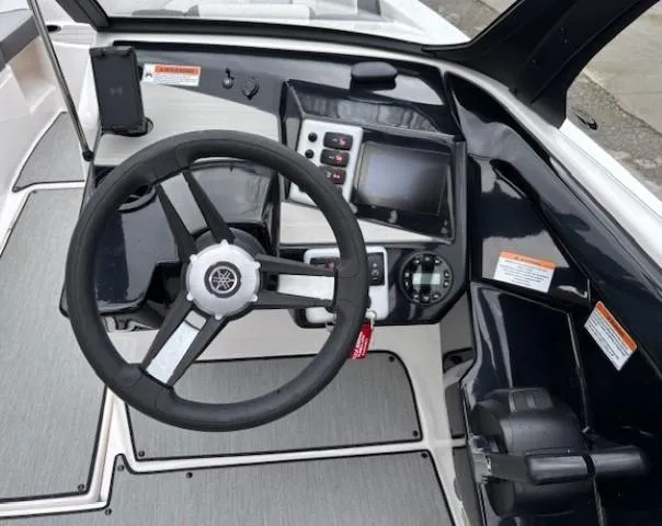 Slide: The Image of 2023 Yamaha Boats AR220 dashboard with steering wheel and control panel. - 14