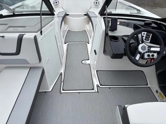 Slide: The Image of 2023 Yamaha Boats AR220 interior with sleek design and modern dashboard. - 18