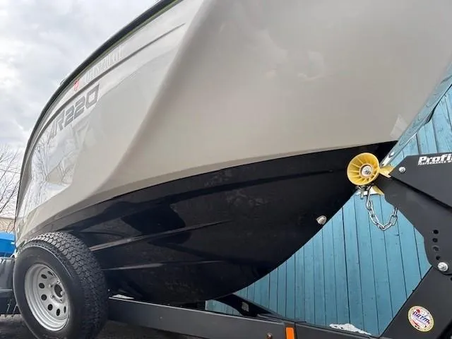 Slide: The Image of 2023 Yamaha Boats AR220 on trailer, showcasing sleek hull design. - 2