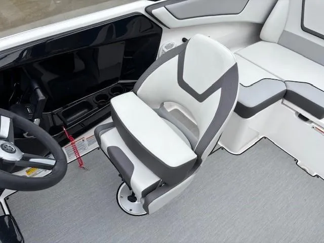 Slide: The Image of 2023 Yamaha Boats AR220 interior with sleek captain's chair and modern dashboard design. - 22