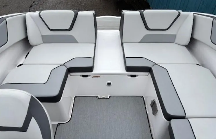 Slide: The Image of 2023 Yamaha Boats AR220 interior seating with modern gray and white upholstery. - 23
