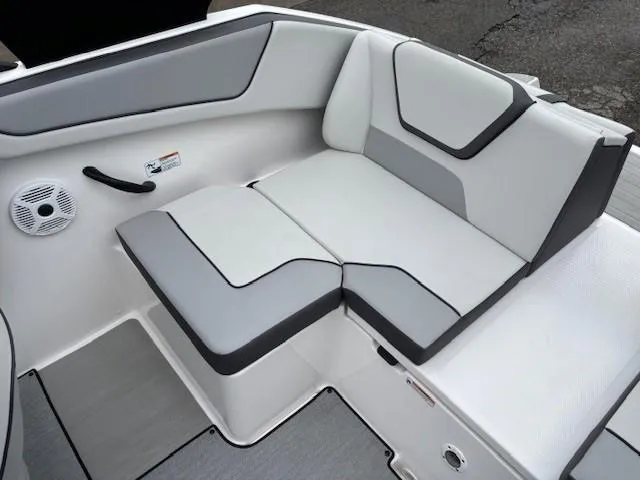 Slide: The Image of 2023 Yamaha Boats AR220 interior seating with gray and white upholstery. - 25