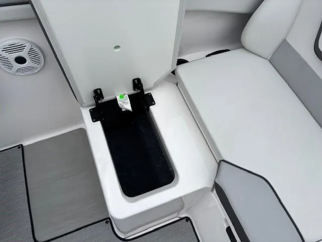 Slide: The Image of 2023 Yamaha Boats AR220 interior seating with storage compartment and speaker. - 26