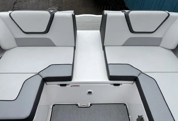 Slide: The Image of 2023 Yamaha Boats AR220 interior seating with modern gray and white upholstery design. - 27