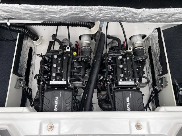 Slide: The Image of 2023 Yamaha AR220 boat engine compartment with dual engines and wiring. - 28