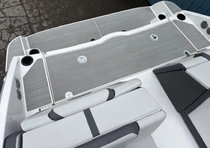 Slide: The Image of 2023 Yamaha Boats AR220 deck with gray seating and cup holders. - 29