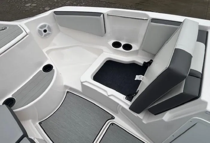 Slide: The Image of 2023 Yamaha Boats AR220 interior with seating, storage, and cup holders. - 9