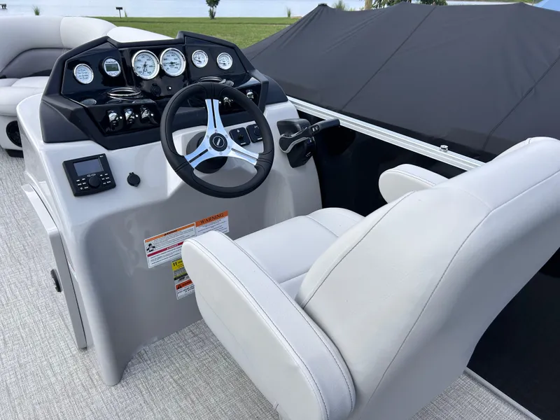 Slide: The Image of 2024 Landau Island Breeze 232 Cruise boat dashboard with steering wheel and gauges. - 3