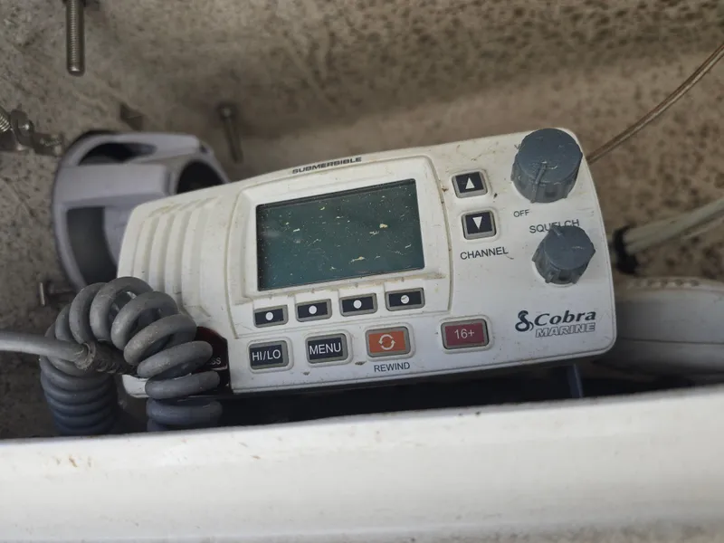 Slide: The Image of Cobra Marine radio on a 2017 NauticStar 231 Coastal boat dashboard. - 11