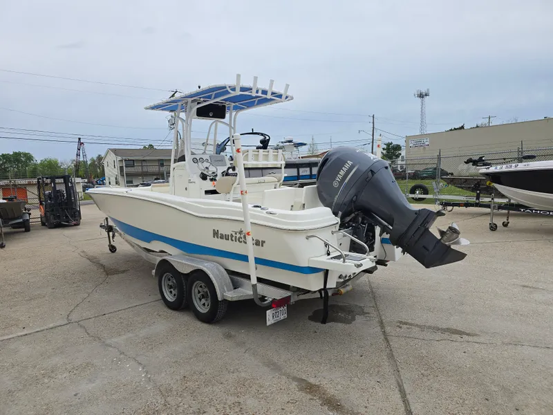 Slide: The Image of 2017 NauticStar 231 Coastal boat on trailer with Yamaha outboard motor in parking lot. - 4