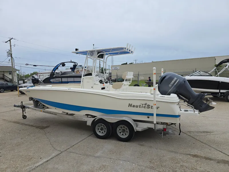 Slide: The Image of 2017 NauticStar 231 Coastal boat on trailer, side view, in a parking lot. - 5