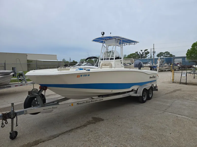 Slide: The Image of 2017 NauticStar 231 Coastal boat on trailer, parked outdoors. - 6