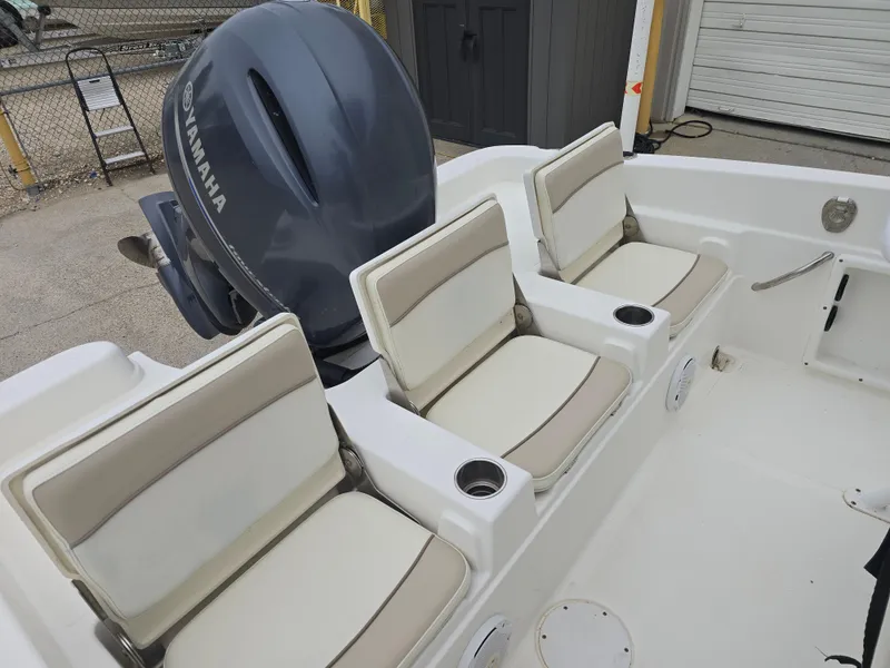 Slide: The Image of 2017 NauticStar 231 Coastal boat seats with Yamaha engine in background. - 9