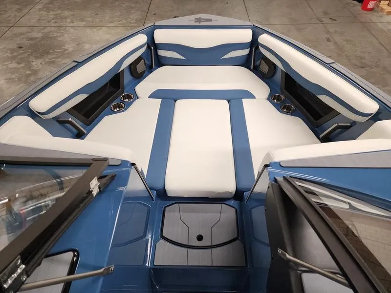 Slide: The Image of Luxurious interior of 2025 Axis T235 boat with blue and white seating. - 11