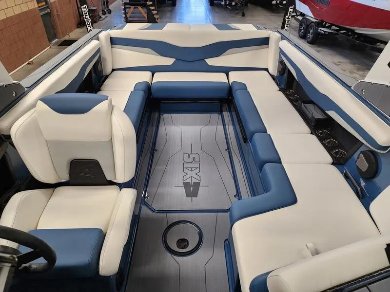 Slide: The Image of 2025 Axis T235 boat interior with blue and white seating, spacious layout. - 12
