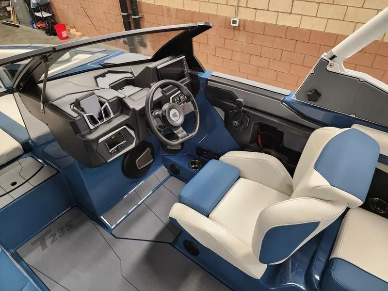 Slide: The Image of Interior of 2025 Axis T235 boat, featuring modern dashboard and comfortable seating. - 13