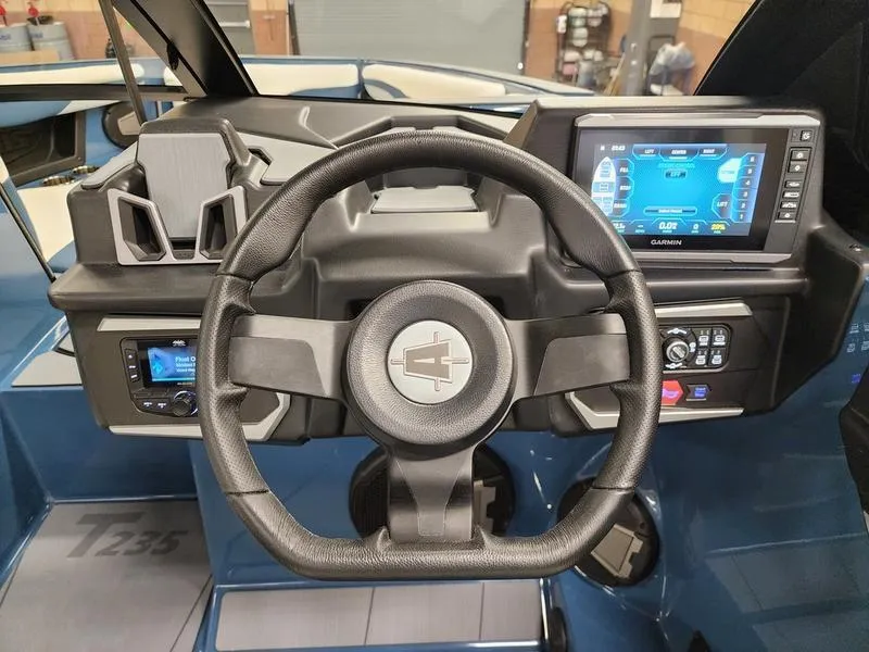 Slide: The Image of 2025 Axis T235 boat dashboard with steering wheel and digital display. - 15