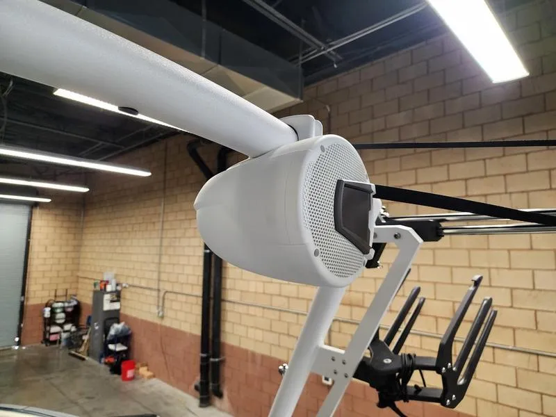 Slide: The Image of 2025 Axis T235 boat speaker in a garage setting, mounted on a white frame. - 23