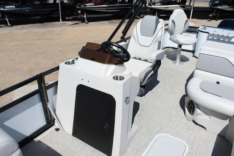 Slide: The Image of 2025 Avalon Venture 85 Rear Fish 23 FT boat interior with steering console and seating. - 15