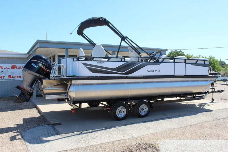 Slide: The Image of 2025 Avalon Venture 85 Rear Fish 23 FT pontoon boat on trailer, displayed at dealership. - 5