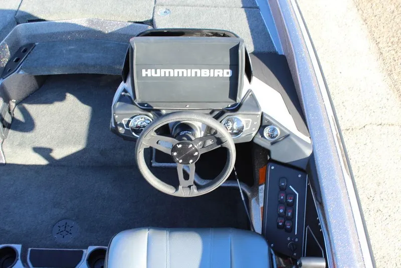 Slide: The Image of 2025 Skeeter ZXR20 boat cockpit with Humminbird navigation system and steering wheel. - 13
