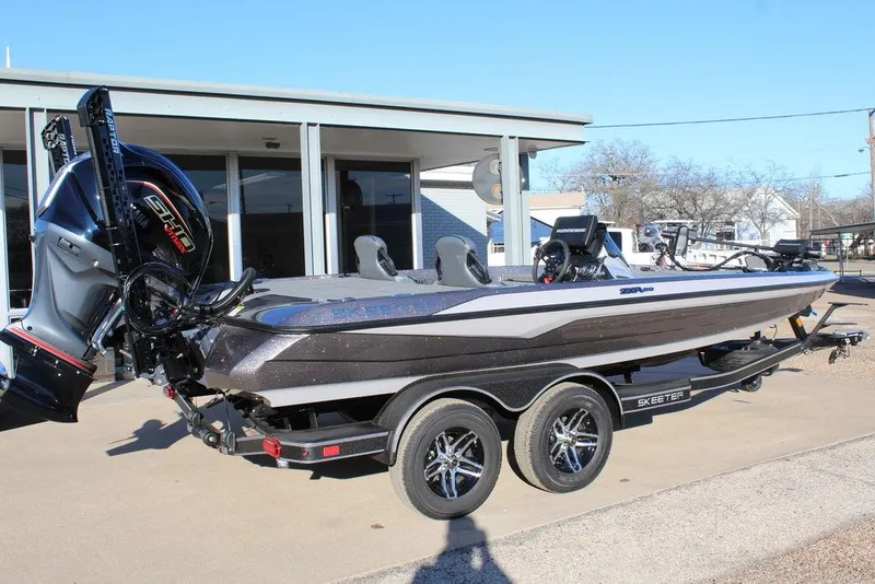 Slide: The Image of 2025 Skeeter ZXR20 boat on trailer, parked outdoors, showcasing sleek design and powerful engine. - 3