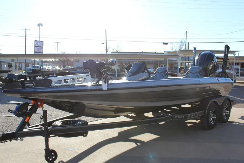 Slide: The Image of 2025 Skeeter ZXR20 bass boat on trailer in outdoor dealership lot. - 6