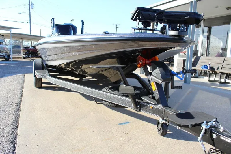 Slide: The Image of 2025 Skeeter ZXR20 boat on trailer, parked outdoors, showcasing sleek design and modern features. - 7