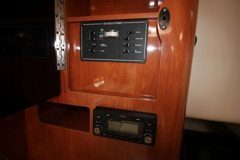 Slide: The Image of 2004 Four Winns 288 Vista control panel with wood finish and electronic display. - 24