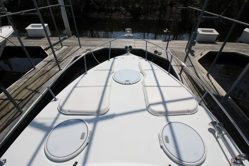 Slide: The Image of 2004 Four Winns 288 Vista boat deck with hatches, docked at marina. - 28