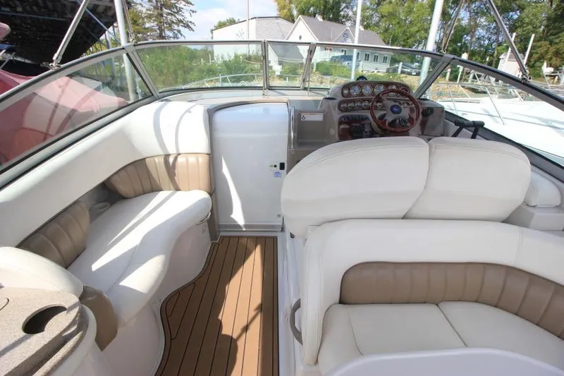 Slide: The Image of 2004 Four Winns 288 Vista boat interior with beige seating and wooden flooring. - 30