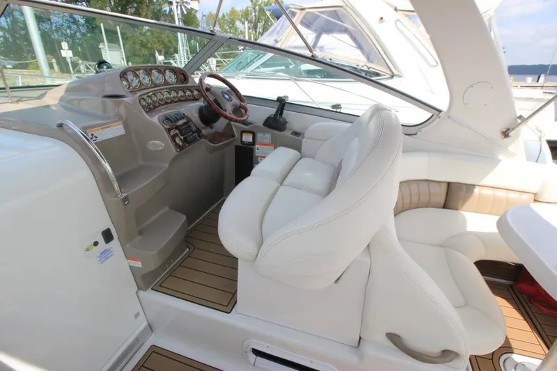 Slide: The Image of 2004 Four Winns 288 Vista boat cockpit with white seating and control panel. - 32