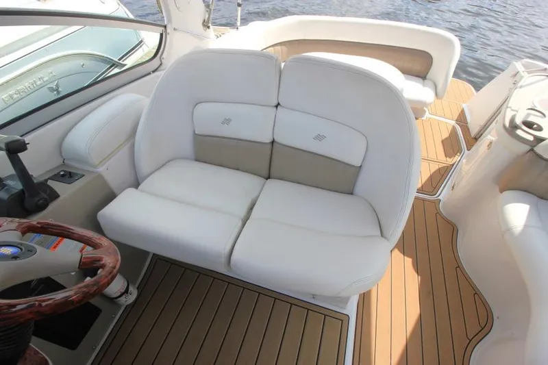 Slide: The Image of 2004 Four Winns 288 Vista boat interior with white seating and wooden flooring. - 33