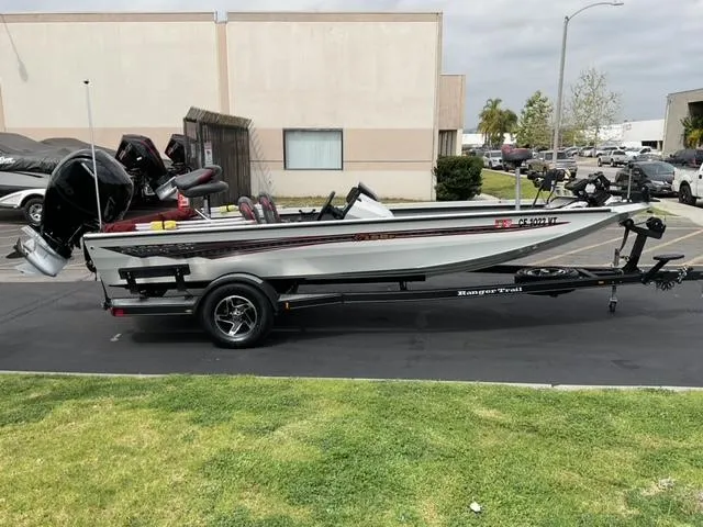 Slide: The Image of 2020 Ranger RT198P boat on trailer parked outdoors. - 0