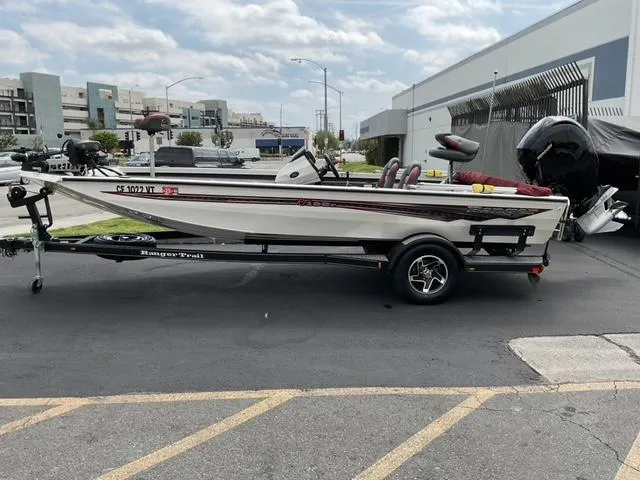 Slide: The Image of 2020 Ranger RT198P fishing boat on trailer, parked outdoors near buildings. - 1