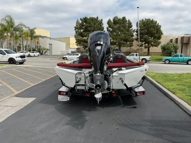 Slide: The Image of 2020 Ranger RT198P boat with outboard motor parked in a lot, rear view. - 3