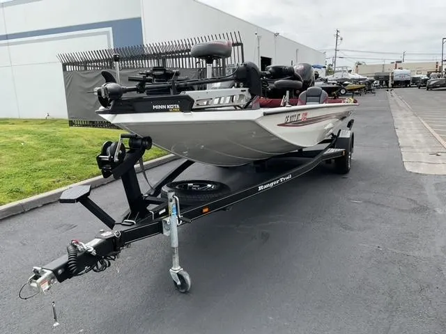 Slide: The Image of 2020 Ranger RT198P boat on trailer, parked outdoors near industrial building. - 4