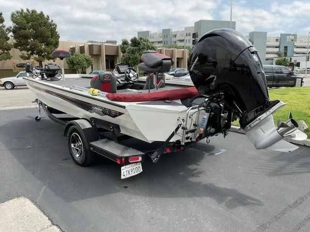 Slide: The Image of 2020 Ranger RT198P boat with outboard motor on a trailer in a parking lot. - 6