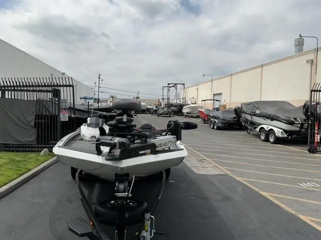 Slide: The Image of 2020 Ranger RT198P boat parked in a lot with other covered boats. - 7