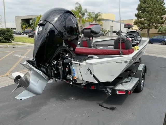 Slide: The Image of 2020 Ranger RT198P boat with powerful outboard motor, parked on a trailer. - 8