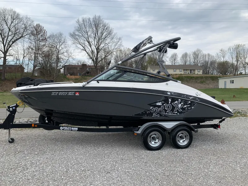 Slide: The Image of 2014 Yamaha Boats 212X on trailer, parked outdoors, with overcast sky. - 1