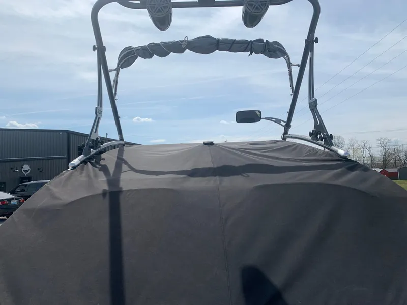 Slide: The Image of 2014 Yamaha Boats 212X with cover and wakeboard tower, parked outdoors. - 3