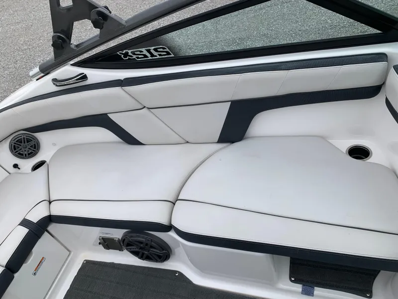 Slide: The Image of 2014 Yamaha Boats 212X interior with white and black seating, cup holders, and speakers. - 6