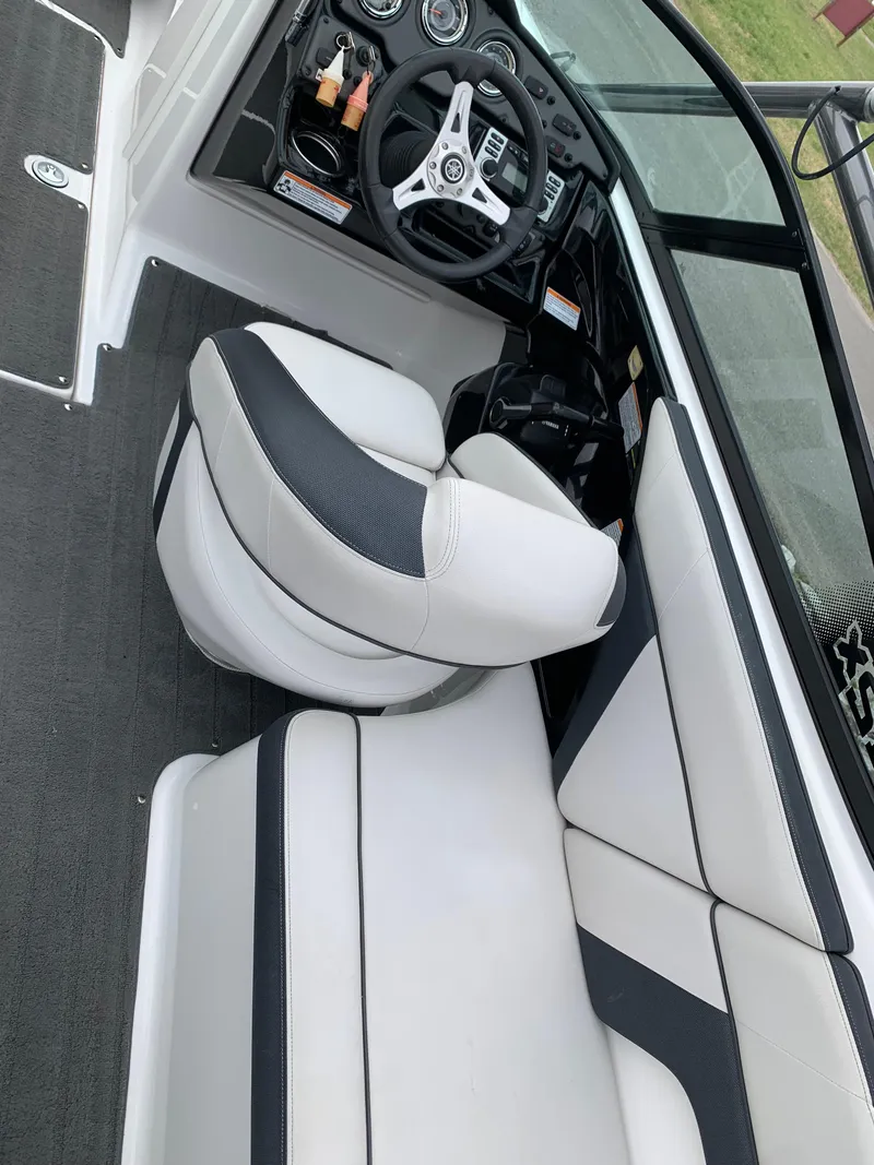 Slide: The Image of 2014 Yamaha Boats 212X interior with sleek seating and modern dashboard design. - 7